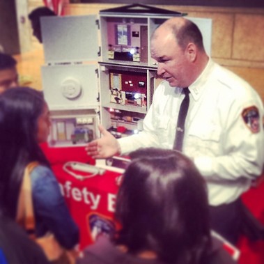 Capt. Kevin Anderson teaches students about fire safety at the college fair for the hearing-impaired.