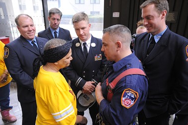 Members of FDNY’s Rescue 1 speak with Carmen Quinones. They saved her from the building collapse in East Harlem on March 11.