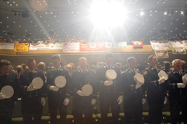 The promoted members. The many banners hung by members of their firehouses are in the background.