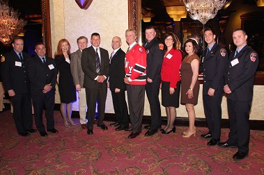 Fire Commissioner Salvatore Cassano, President and CEO of the New York Blood Center Dr. Christopher Hillyer join Firefighter Robert Wiedmann (fifth from the left) as he met 12 of the blood donors who helped save his life.