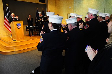 Fire Commissioner Salvatore Cassano receives a standing ovation from the audience.
