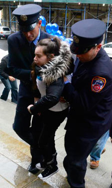 FDNY firefighters help girls with Rett Syndrome climb the Tweed Courthouse steps at the annual Blue Sky Girls event.