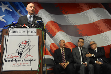 Former Fire Commissioner Salvatore Cassano speaks to the crowd. (L to R) Frank Siller, Chairman and CEO of the Stephen Siller Tunnel to Towers Foundation; Fire Commissioner Daniel Nigro; and former NYC Mayor Rudolph Giuliani. 