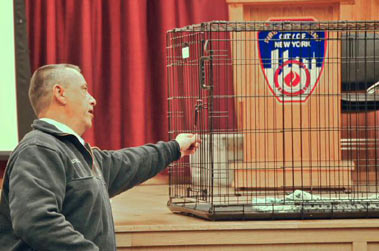Lt. Kelly with the cage in which he caught the dog.