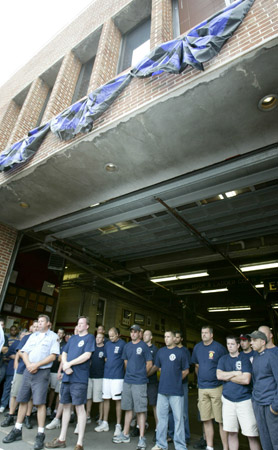 Firefighters, neighbors and friends mourn the loss of Firefighters Joseph Graffagnino and Robert Beddia at Engine Company 24/Ladder Company 5. The firefighters lost their lives in a seven-alarm fire on August 18. Photo courtesy of G.N.Miller/NY Post
