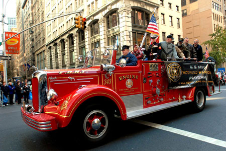 Firefighter Danny Prince drives a ceremonial fire rig carrying veterans who have served in the wars in Iraq and Afghanistan, as well as in World War II and the Korean War. The FDNY supports local veterans through partnerships with the Brooklyn Purple Hearts and Wounded Warriors at Fort Hamilton.