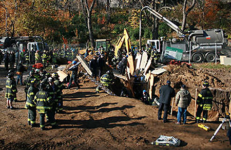 Firefighters and EMS members help rescue a construction worker caught in a trench collapse. Photo courtesy of FF David Raynor, Rescue Battalion