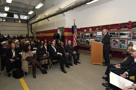 Fire Commissioner Scoppetta addresses the crowd gathered on the new firehouse's apparatus floor for the ribbon cutting.