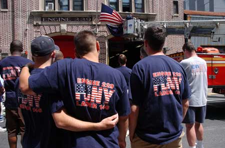 Firefighters at Ladder 146 hang bunting in honor of Firefighter Daniel F. Pujdak at their quarters in Brooklyn on June 22. Photo courtesy of Photographer Michael Schwartz, New York Daily News.