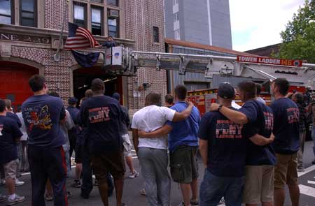 Firefighters at Ladder 146 hang bunting in honor of Firefighter Daniel F. Pujdak at their quarters in Brooklyn on June 22. Photo courtesy of Photographer Michael Schwartz, New York Daily News.