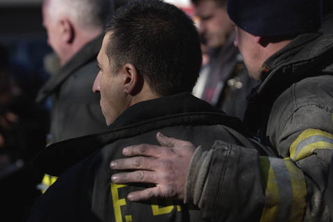 Firefighters from Engine 249/Ladder 113 mourn the loss of Lt. John Martinson on January 4. Lt. Martinson sustained critical injuries while battling a fire in the Ebbets Field Houses on January 3.