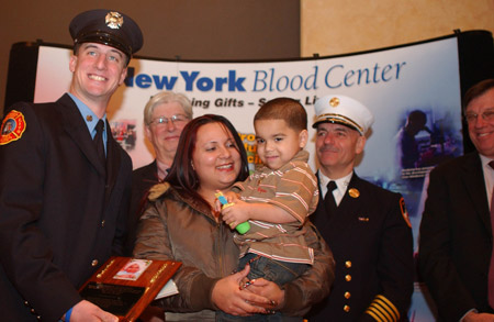 Firefighter William Zask, Jr., from Engine 257 meets his bone marrow recipient, 3-year-old Alex Jomar Maldonado Cruz, and his mother, Jeinny Cruz, for the first time during the annual Honor Roll of Life event.