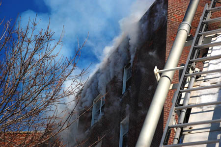 Officials study the science of wind-driven high-rise fires during experiments in an abandoned apartment building on Governors Island.
