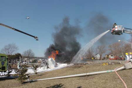 A 9,000-gallon gas truck overturned and burst into flames at around 1215 hours. Approximately 280 firefighters used a special alcohol-based foam to douse the flames. The fire was deemed under control in approximately two hours. The driver of the tanker was killed by the extreme conditions.
