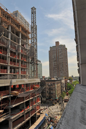 1577 - The remaining piece of the crane stands above East 91 Street and First Avenue.