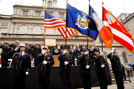 The FDNY Color Guard stands at attention as Firefighter Frank Pizarro sings the National Anthem.