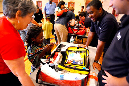 Paramedics and EMTs show students, parents and teachers the tools they carry in their trauma bags.