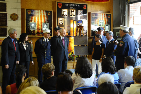 FDNY Chaplain Msgr. John Delendick blesses the plaques for Lt. Joseph Graffagnino and Firefighter Robert Beddia. (L to R) Firefighter Beddia's brother, Ed Carman, and sister, Susan Beddia Olson; Chief of Department Salvatore Cassano; Fire Commissioner Nicholas Scoppetta; Lt. Graffagnino's wife, Linda; Mayor Michael Bloomberg; and Lt. Graffagnino's father, Joseph Graffagnino.