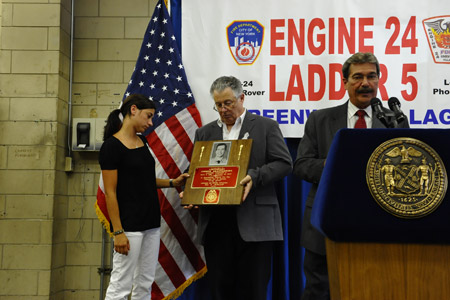 Linda Graffagnino, Lt. Joseph Graffagnino's wife, receives a plaque and Medal of Supreme Sacrifice from the Uniformed Fire Officers Association. Firefighter Robert Beddia's family received a similar plaque and medal from the Uniformed Firefighters Association.