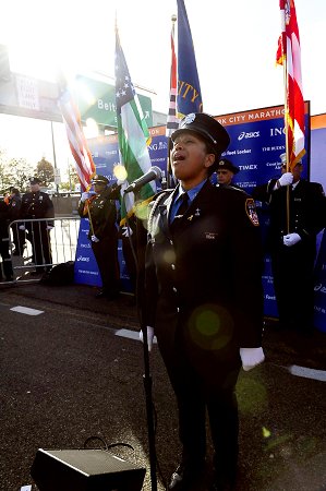 Firefighter Regina Wilson of Engine 219 sings the National Anthem at the start of the 2008 ING New York City Marathon on Staten Island.