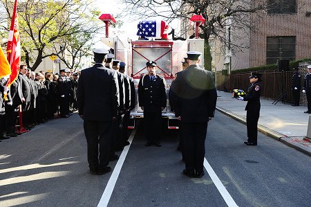 Probationary firefighters from Firefighter Sears's class prepare to unload the casket from the caisson.