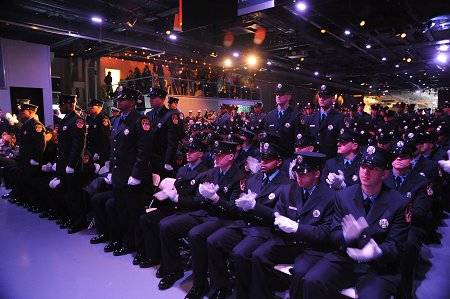 Seventy-two of graduates who are veterans of the U.S. military stand to be recognized during the ceremony.