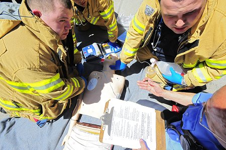 EMTs treat a simulated victim who went in to cardiac arrest during the 2009 EMS Competition.