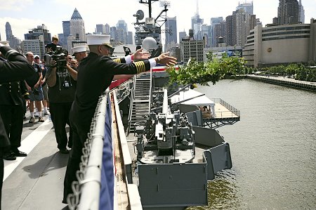 Chief of Department Salvatore Cassano drops a ceremonial wreath into the Hudson River during the Blessing of the Fleet ceremony.