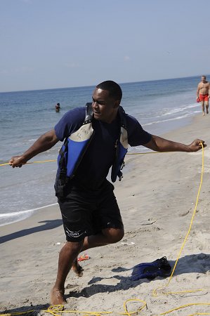 FF Ray Ferrer from Ladder 166 helps pull the firefighters and the victim to shore during a water rescue drill on Coney Island.