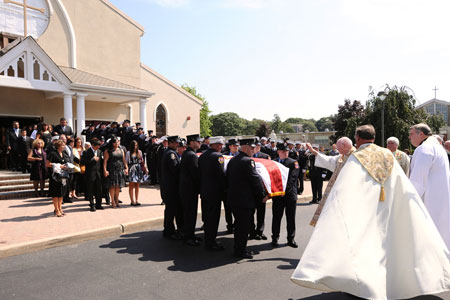 FF Paul Warhola's family, including his wife, Arleen, and children, Paul and Tiana, attended the funeral service at St. John the Evangelist RC Church in Center Moriches, Long Island. 