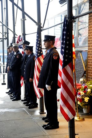 Firefighters stand in front of the Sept. 11 memorial, outside the quarters of Engine 10/Ladder 10, on the eighth anniversary of the attacks.