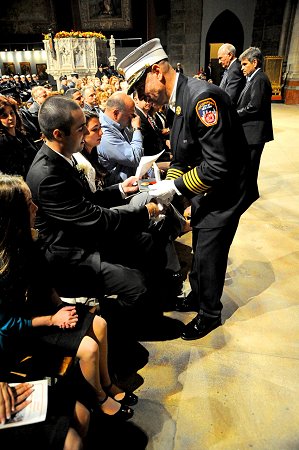 Chief of Department Salvatore Cassano presents the Medal of Valor to Lt. Robert Ryan's son, Chris. Lt. Ryan of Engine 155 died on Nov. 23, 2008, from injuries sustained while operating at a second alarm fire on Staten Island.
