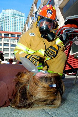 An EMT treats the simulated victim of an allergic reaction to bee stings during the BLS competition.