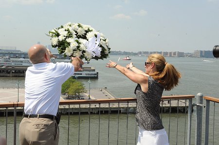 Fire Commissioner Salvatore Cassano and Executive Director of the Intrepid Sea, Air and Space Museum Susan Marenoff throw a wreath into the Hudson River in honor of the Blessing of the Fleet.