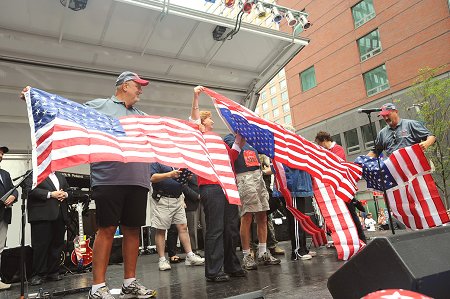 The Siller family at the 9th Annual Tunnel to Towers Run, holding a flag that flew in Afghanistan.