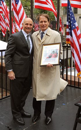 Fire Commissioner Salvatore Cassano gives Tom Madden, Senior Managing Director of Tishman Speyer, a Certificate of Appreciation for his organization's help with Fire Prevention Week.
