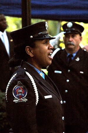 Firefighter Regina Wilson sings the National Anthem at the Memorial Day ceremony.