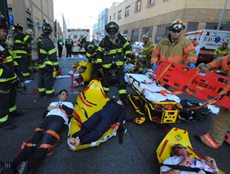 Firefighters and EMS members treat volunteers playing victims during the drill.