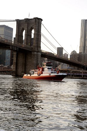 The new fireboat passes under the Brooklyn Bridge.