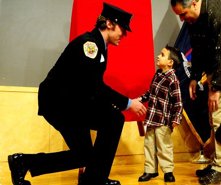 Firefighter Owen Fay, Engine 33, meets his recipient, 5-year-old Luca Campana.