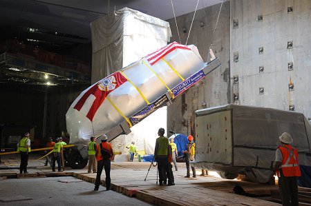 Ladder 3's apparatus, which was covered to protect it and draped with an American and FDNY flag, was lowered into the Museum.
