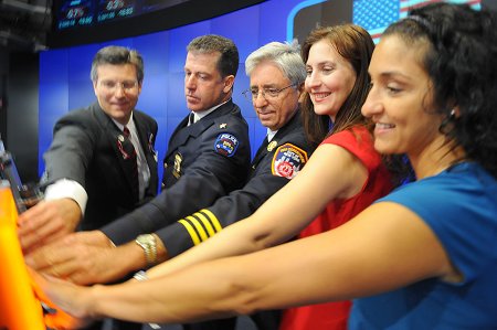 Manhattan Borough Commander James Esposito (center) and members of Engine 65 (not pictured) rang the opening bell of the NASDAQ on Sept. 9, in honor of the 10th anniversary of the Sept. 11 attacks, with members of various 9/11-related organizations.