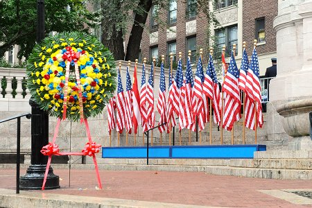 Flags and a wreath placed at the Fireman's Monument.