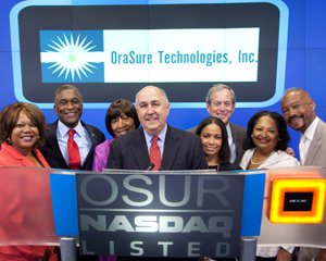 LaRay Brown, HHC Senior VP, 2nd from right, joined Douglas A. Michels, OraSure Pres. & CEO, center, at NASDAQ. (Photo: © 2012, The NASDAQ OMX Group, Inc.)