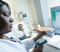 Nurse using computer for medication safety.