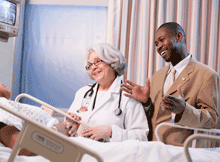 Language interpreter Seydou Sow with a doctor and patient at Harlem Hospital.