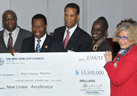 Council Member Mathieu Eugene (center) presents a $3.5M check to Kings County Hospital SVP George Proctor and Acting Executive Director Roslyn Weinstein Council Member Mathieu Eugene (center) presents a $3.5M check to Kings County Hospital SVP George Proctor and Acting Executive Director Roslyn Weinstein