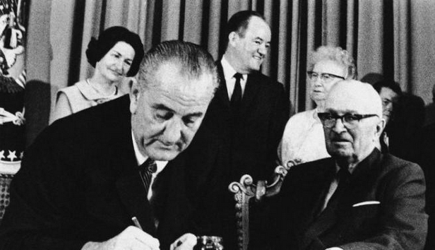 President Lyndon B Johnson signs Medicaid and Medicare into law (1965)