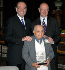 HHC President Alan D. Aviles and HHC Board Chairman Michael A. Stocker congratulate volunteer Tiburico