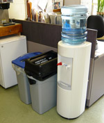 trash container next to bottle and can recycling container